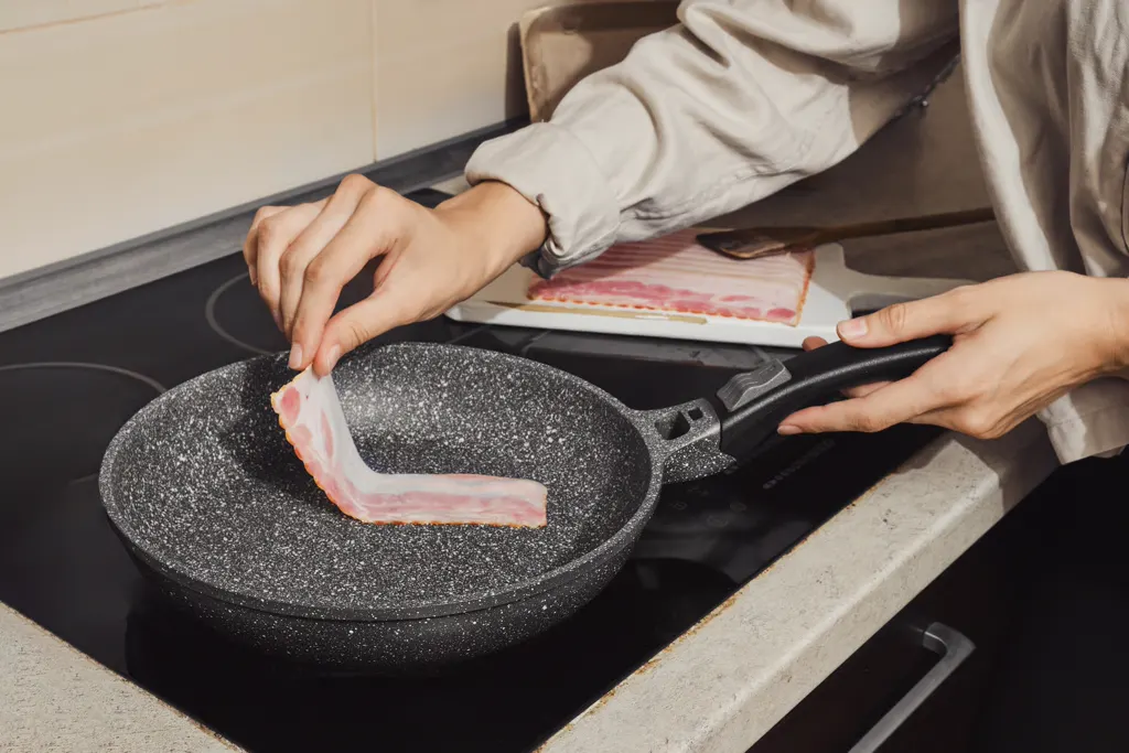 Cooking bacon in a frying pan for beef bourguignon