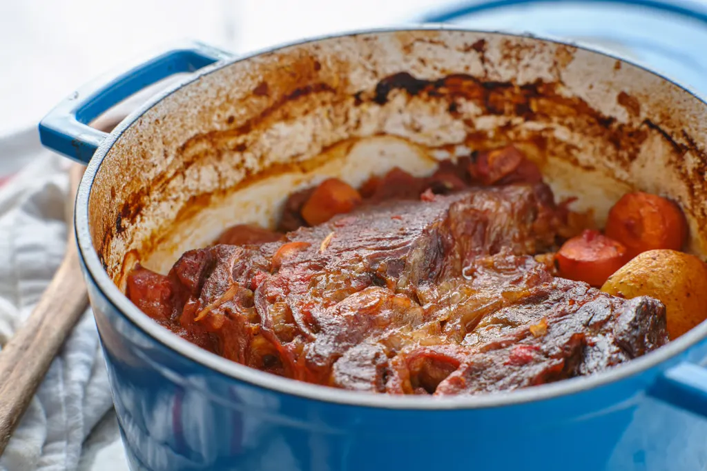 Beef bourguignon simmering in a dutch oven