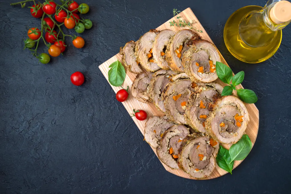 Sliced braciole roulade with vegetables and tomatoes
