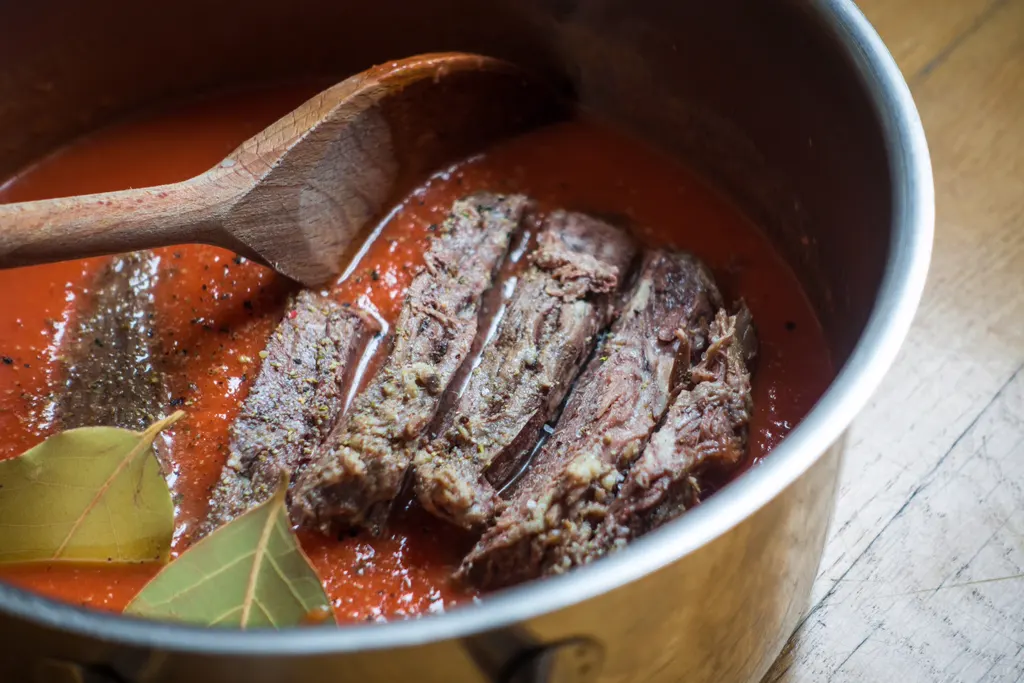 Braciole simmering in tomato sauce