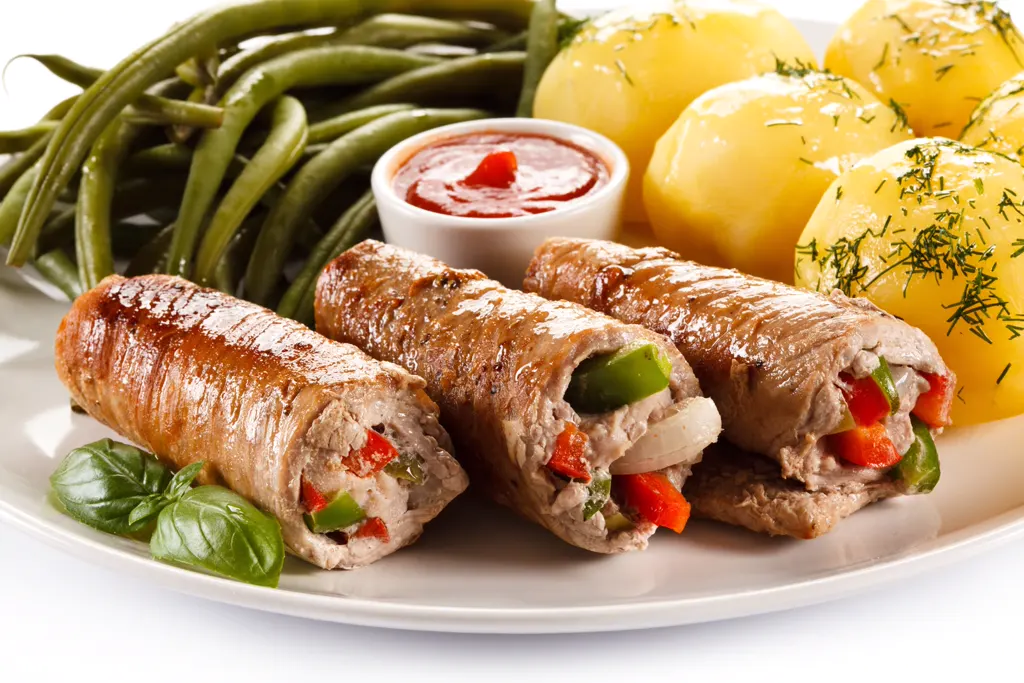 Stuffed beef rolls served with green beans