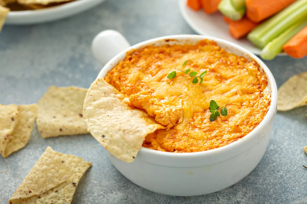 Bubbly cheesy crack chicken dip with tortilla chips and vegetables