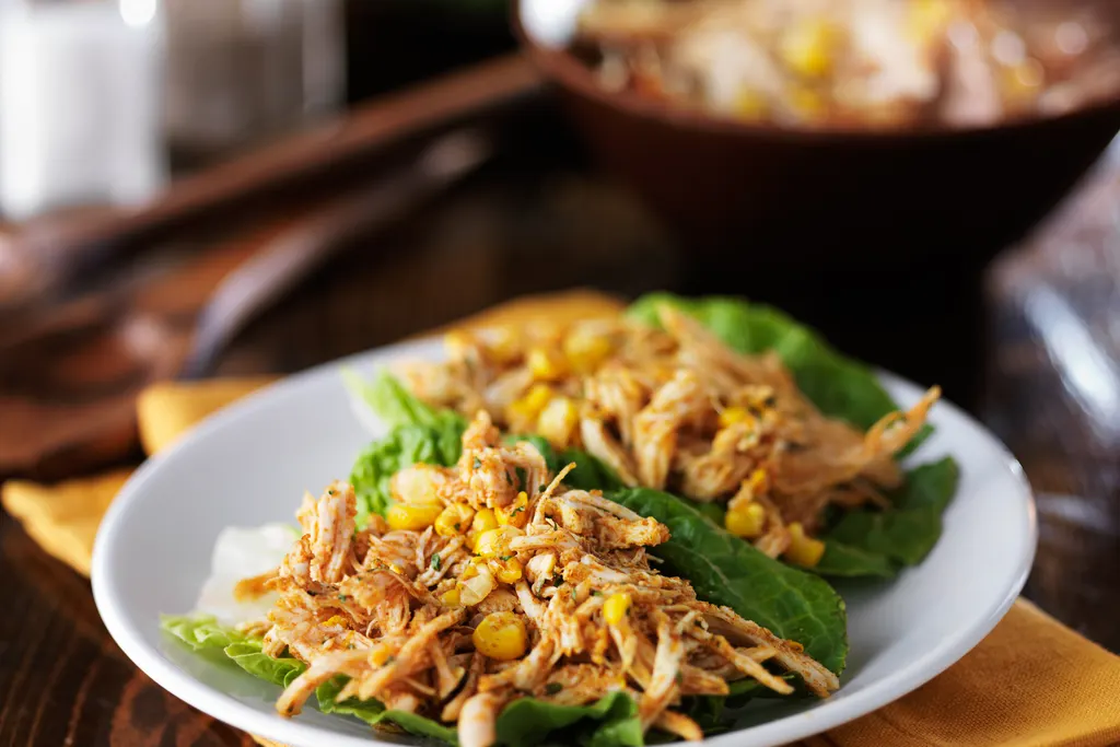Chicken and corn served in lettuce wraps