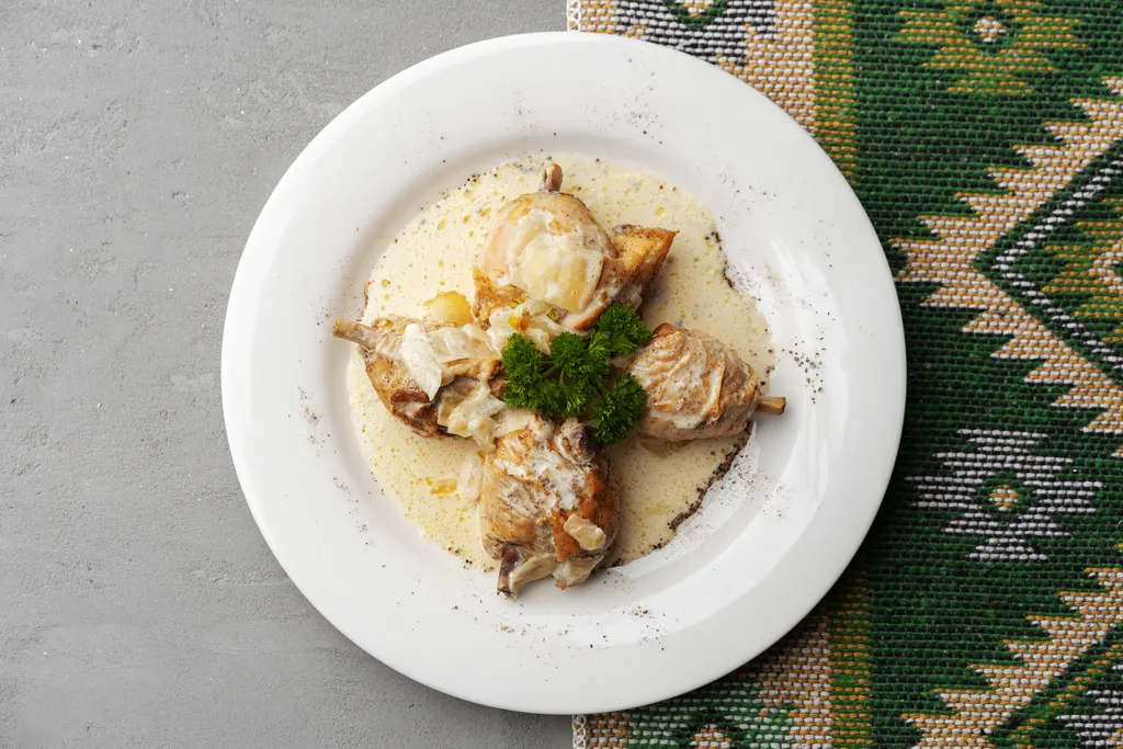 Chicken dish with creamy sauce, overhead view