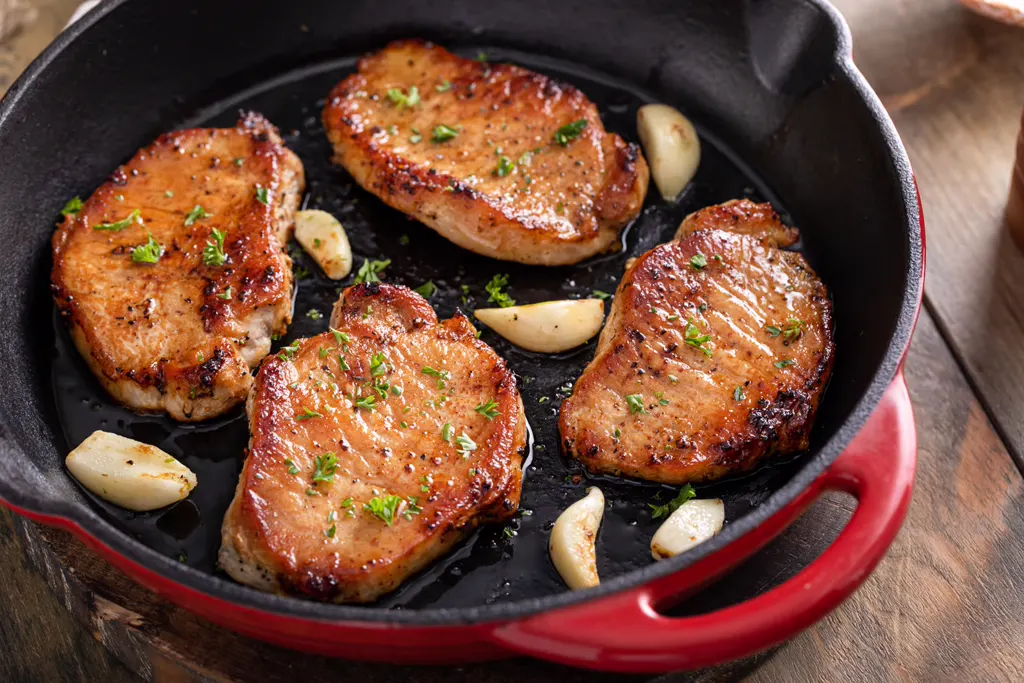 Honey garlic pork chops in a cast iron pan