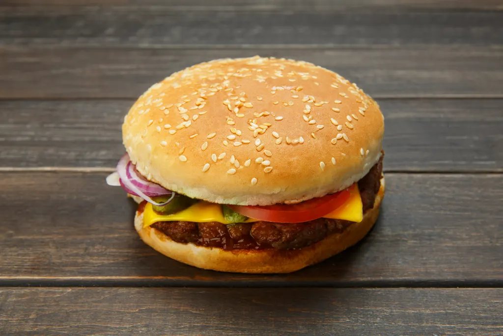Classic burger with fresh toppings on a rustic wood surface