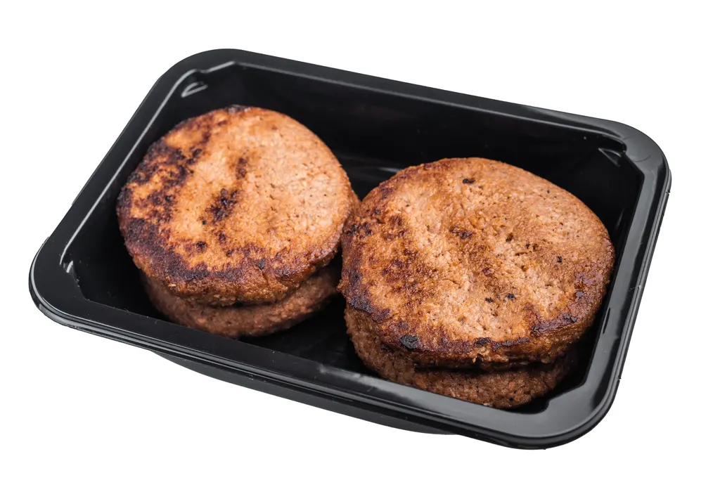 Grilled burger patties stored in a food container