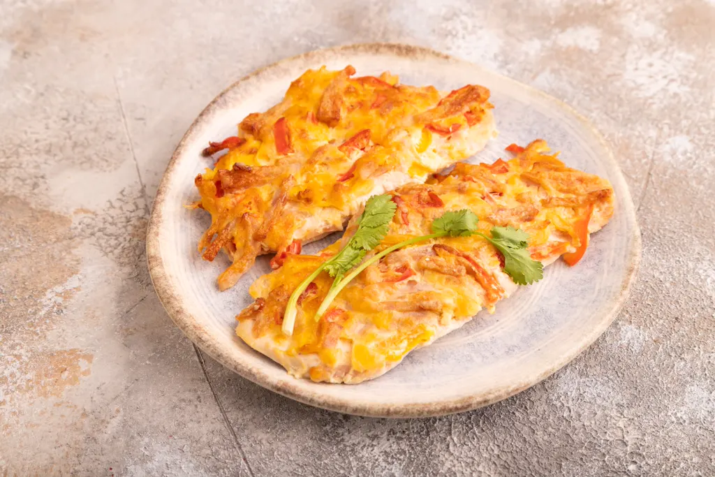 Baked chicken with melted cheese and peppers