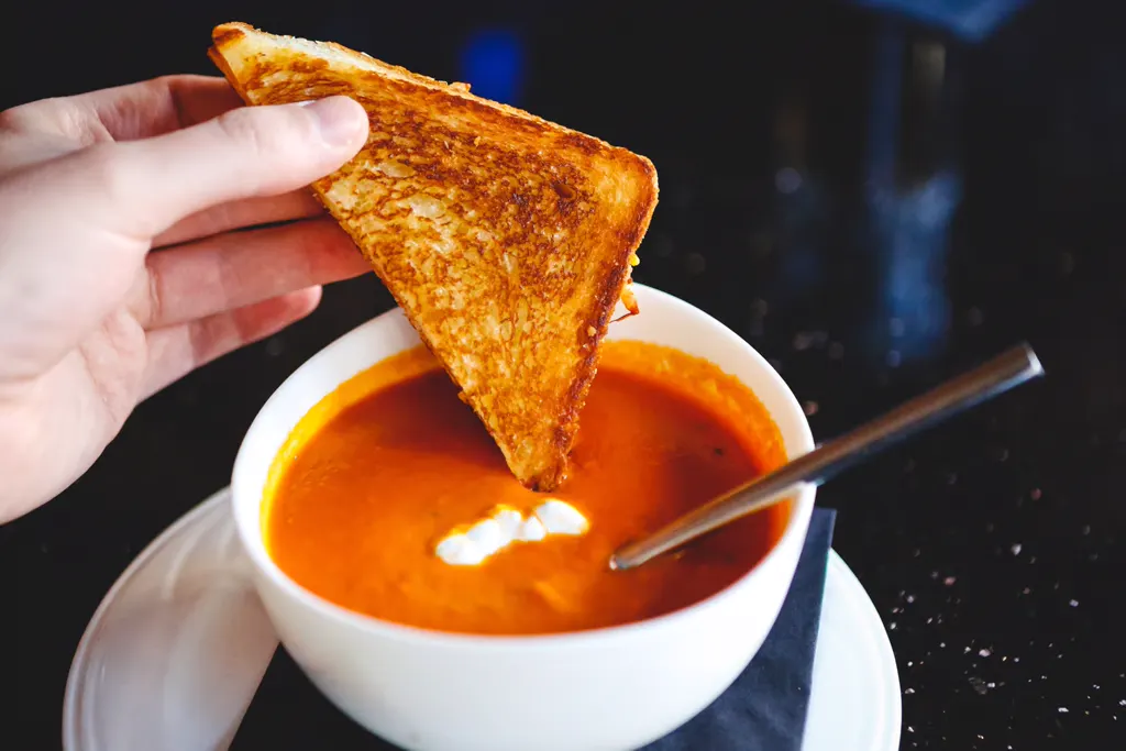 Grilled cheese dipped in creamy tomato soup
