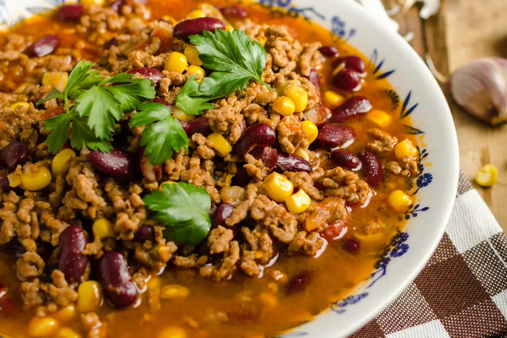 Hearty taco soup with beans, corn and parsley