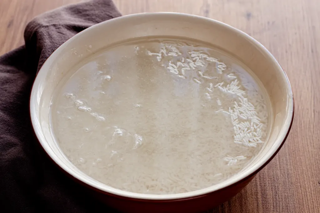 Rice soaking in water in a bowl
