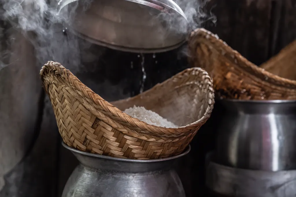 Sticky rice steaming in a traditional woven basket