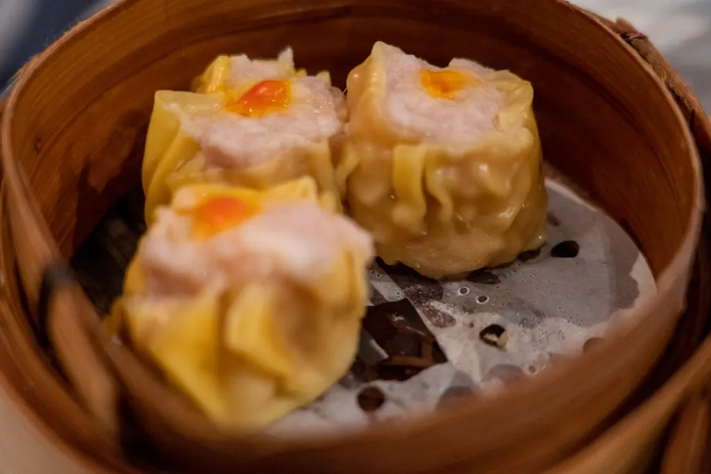 Sticky rice dim sum in a bamboo steamer